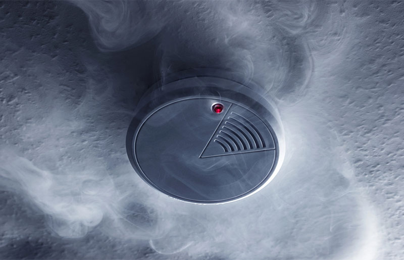 Stock image- smoke detector-The Mad Hatter a smoke detector surrounded by smoke